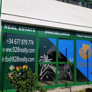Fachada en combinación de vinilos traslúcidos, esmerilado, de impresión y de corte. Diseño de Mochita. 928 Real Estate fachada